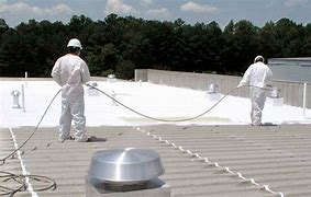 Workers Applying Roof Coating Spray